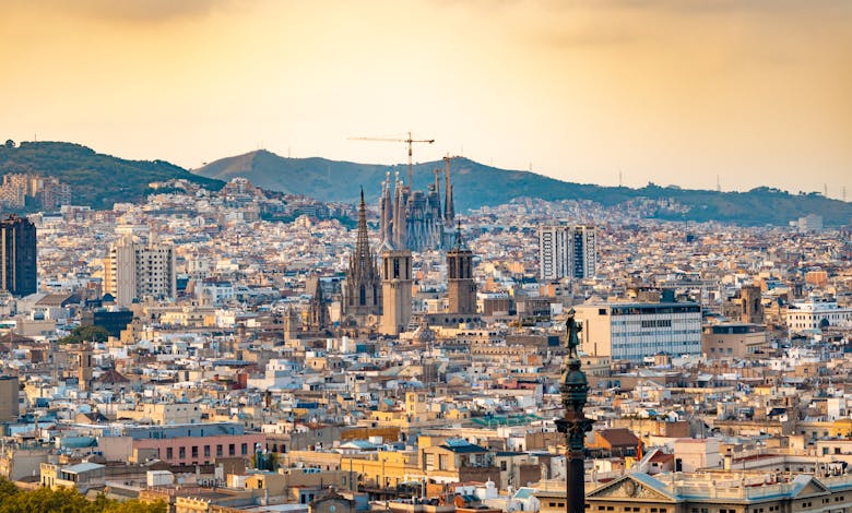 A breathtaking aerial view of Barcelona featuring the iconic Sagrada Familia at sunset.